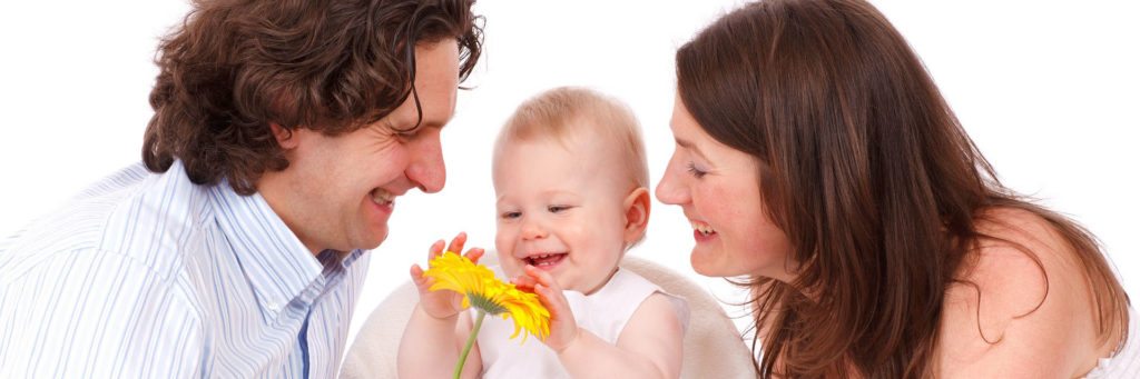 Family smiling with sunflower